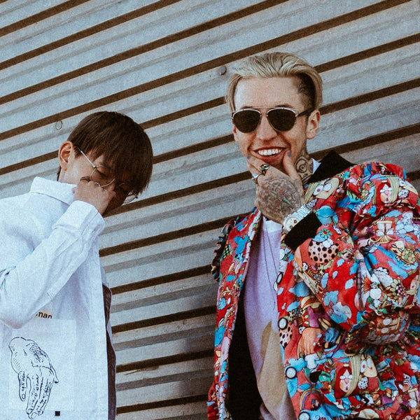 Man posing with friend in front of garage door and wearing the Majestic Duo.