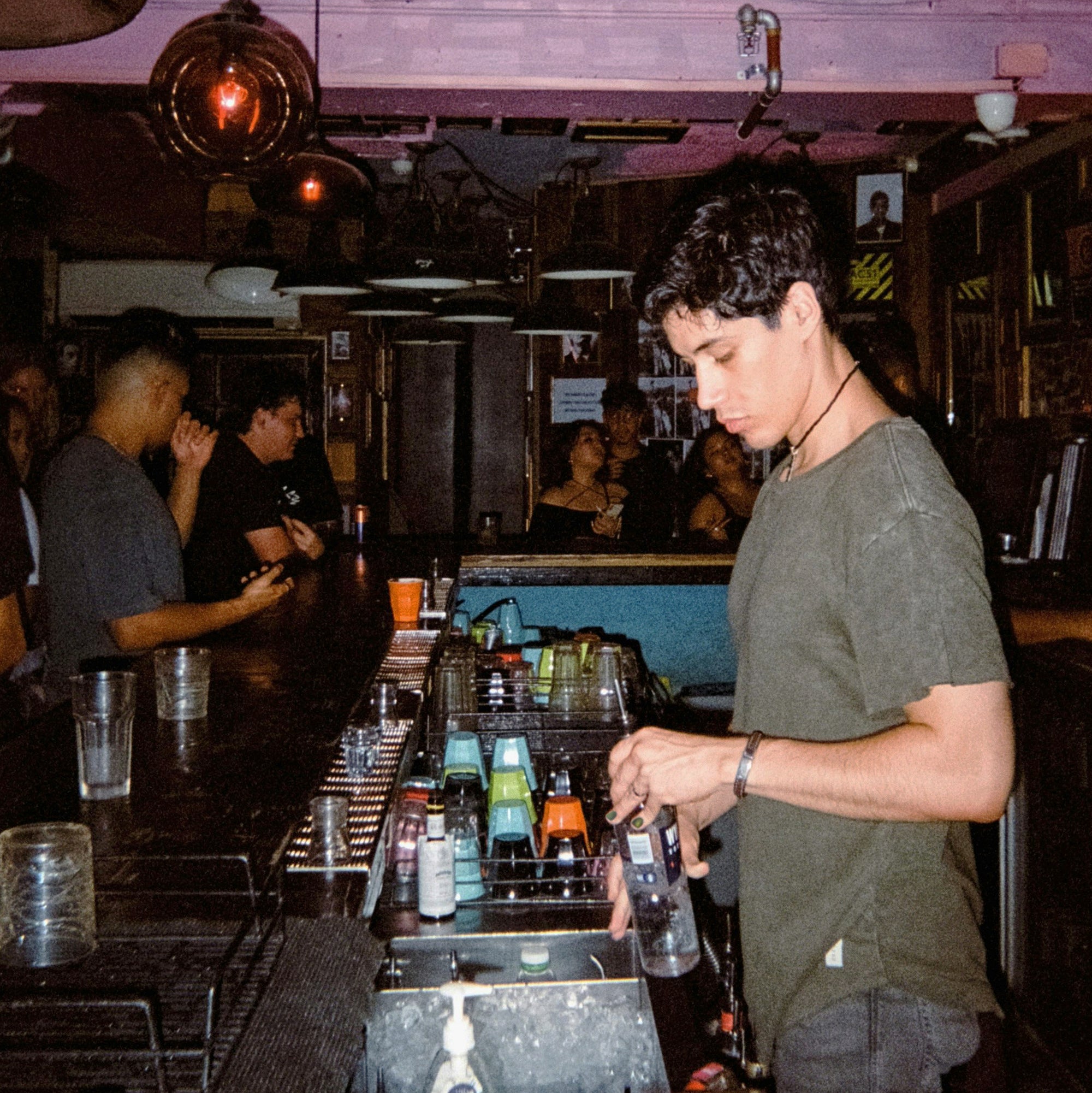 Bartender fixing a drink while wearing the Wanderer Duo.