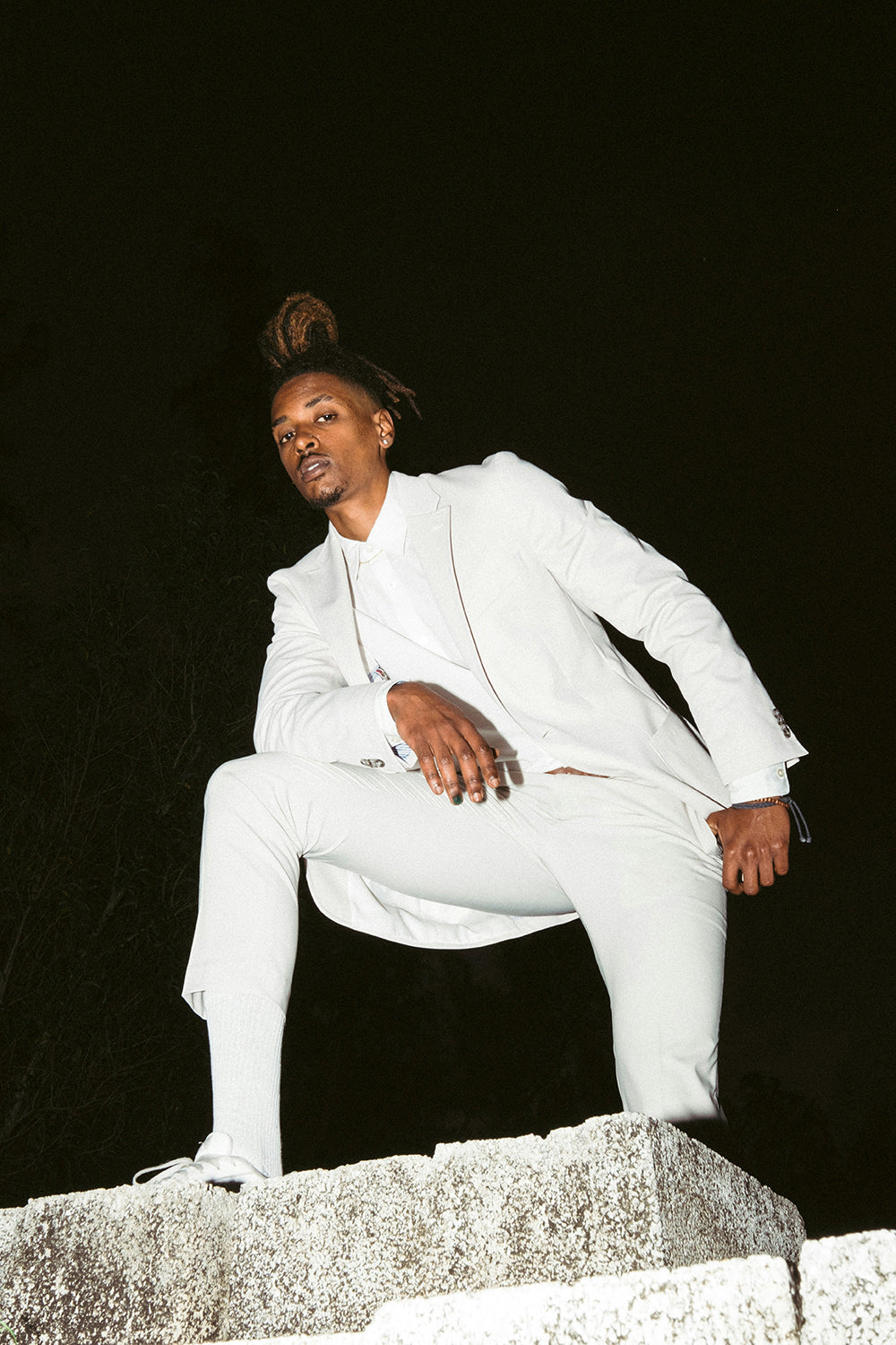 Stylish man in white suit wearing XY nail polish